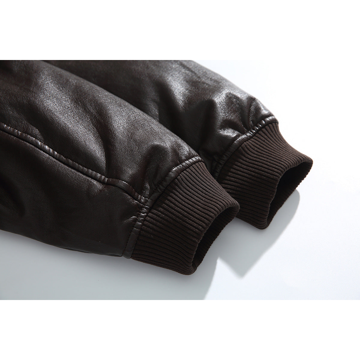 Close-up of the jacket's dark, glossy sleeves and ribbed cuffs.