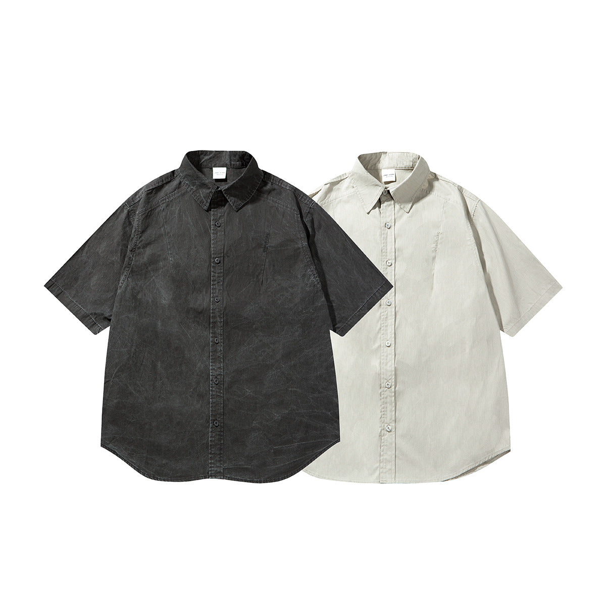 Two short-sleeve button-up shirts shown from the front: one charcoal and one light beige.