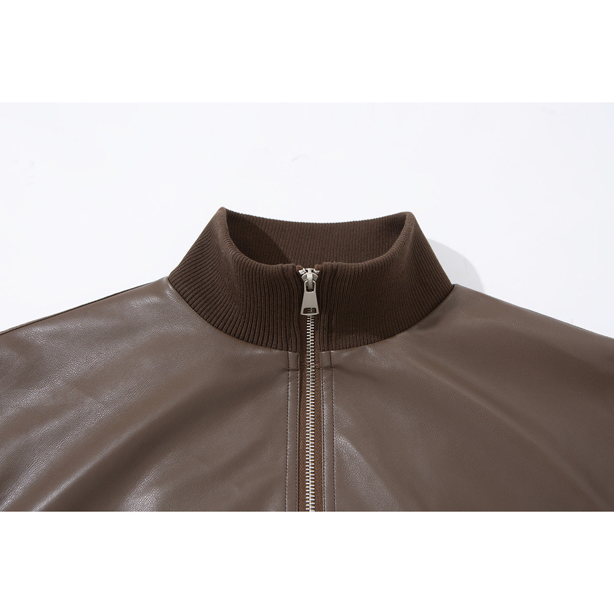 Close-up of a brown jacket's ribbed stand collar and silver front zipper.