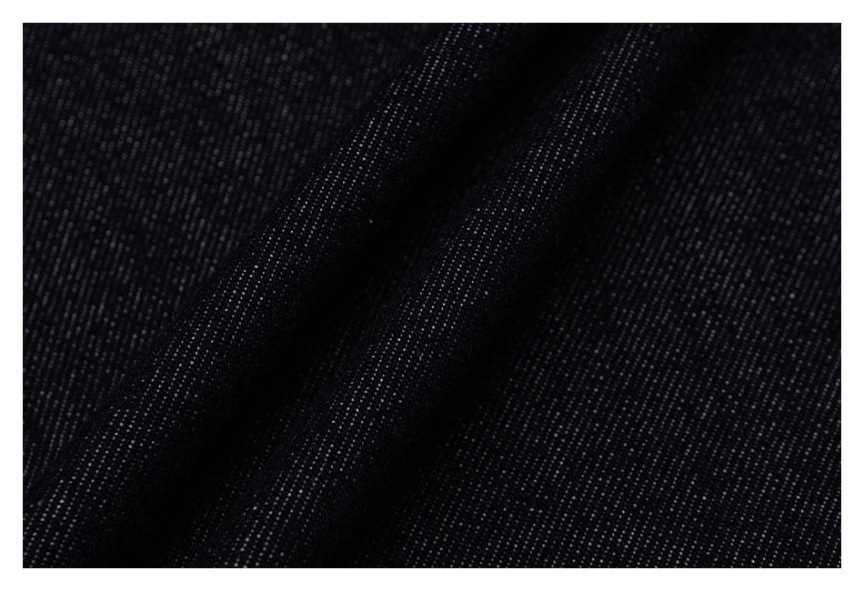 Macro view of the dark indigo denim's textured weave.