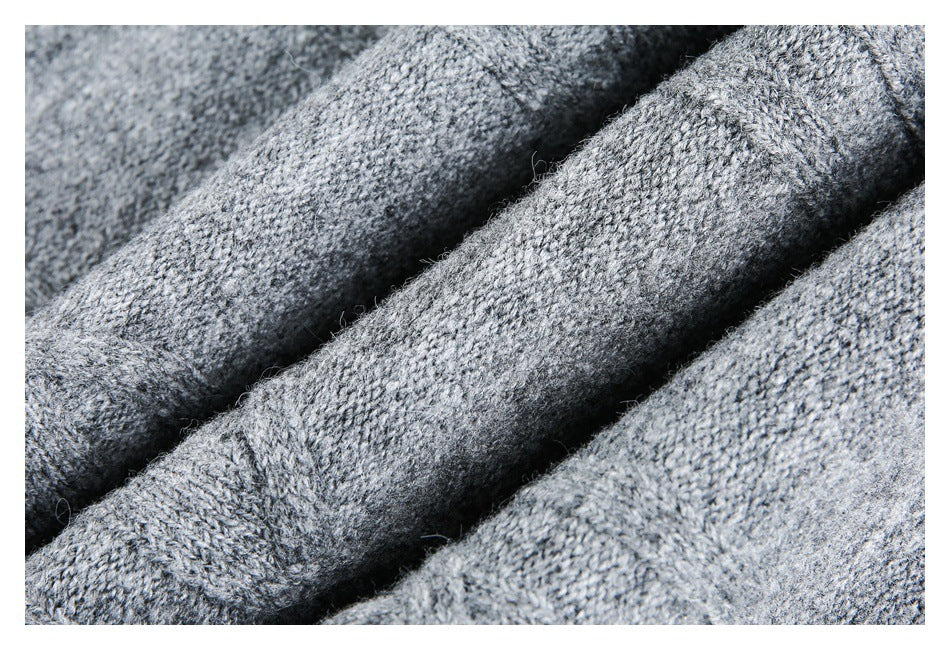 Macro view of the heather gray knit texture, with folded sections of the garment.