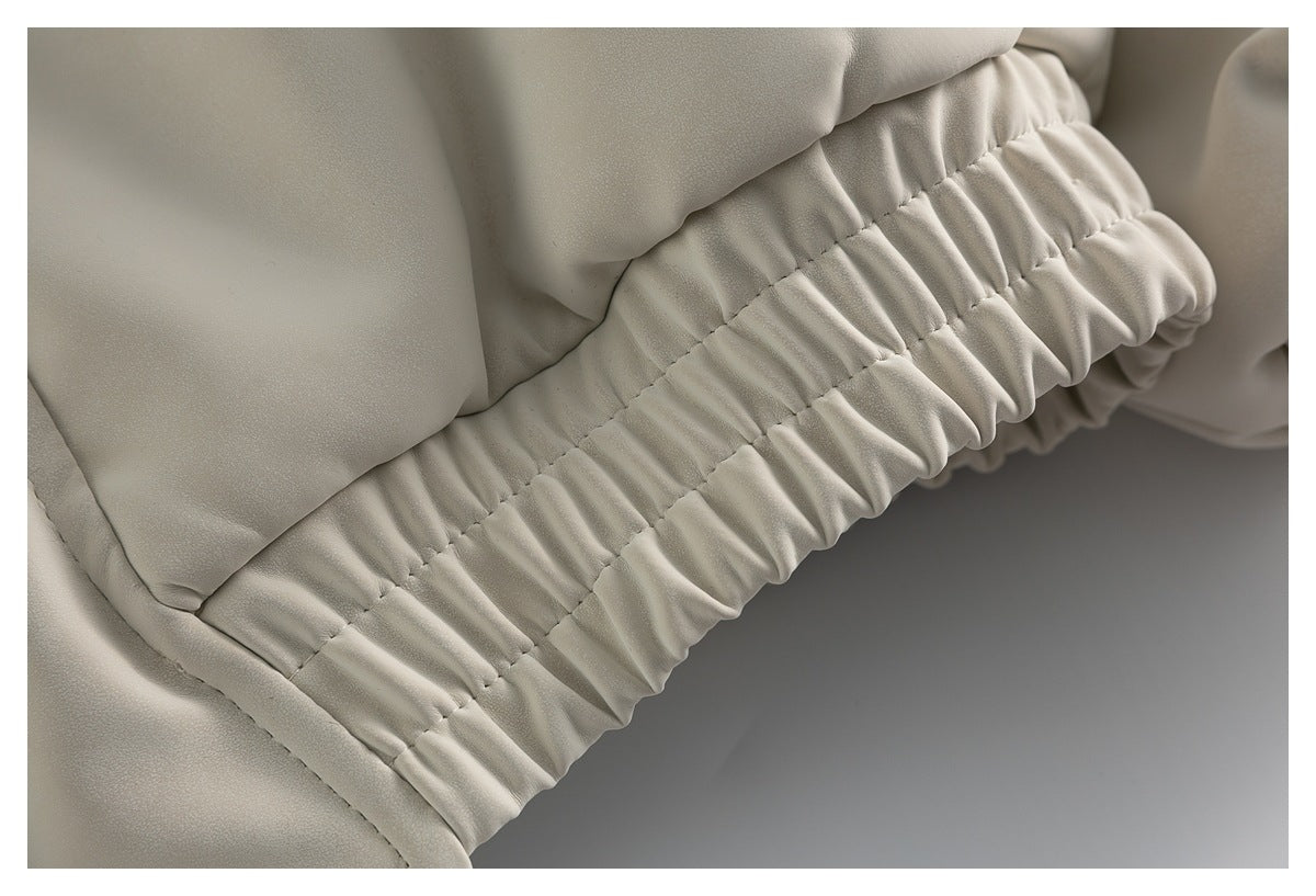 Close-up of the jacket's gathered elastic hem with parallel rows of stitching.