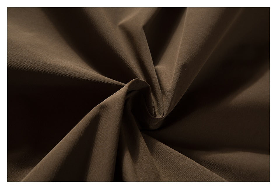 Close-up of brown fabric gathered into folds.