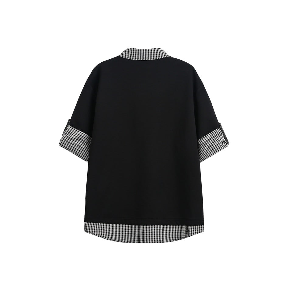Back view of a black oversized top with black-and-white checked collar, sleeve cuffs, and curved layered hem.