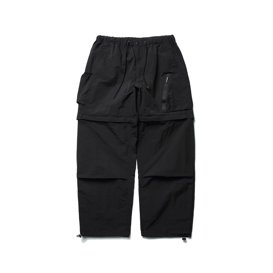 Black wide-leg convertible cargo pants with drawstring waist, side cargo pocket, zip pocket and toggle hems, front view