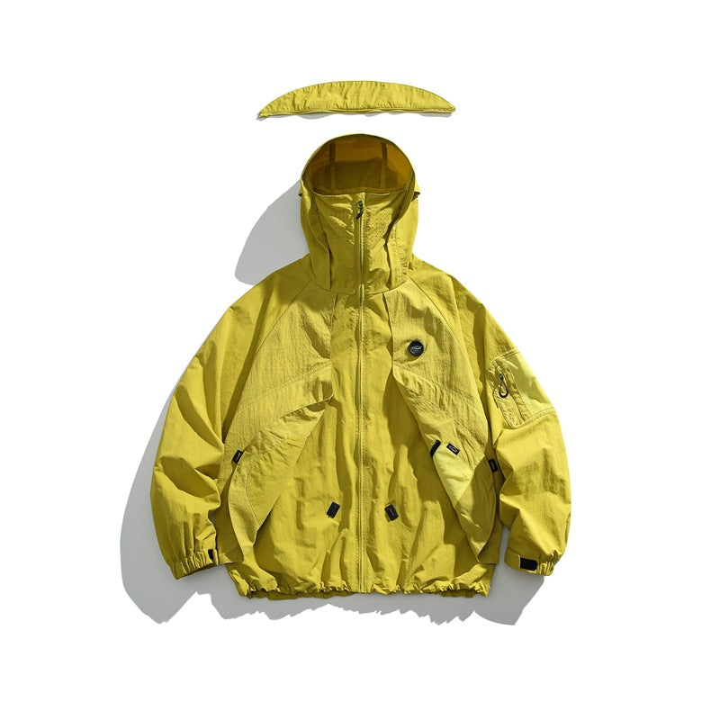 Bright yellow hooded jacket with a front zipper and multiple pockets; a curved matching piece is displayed above the hood.
