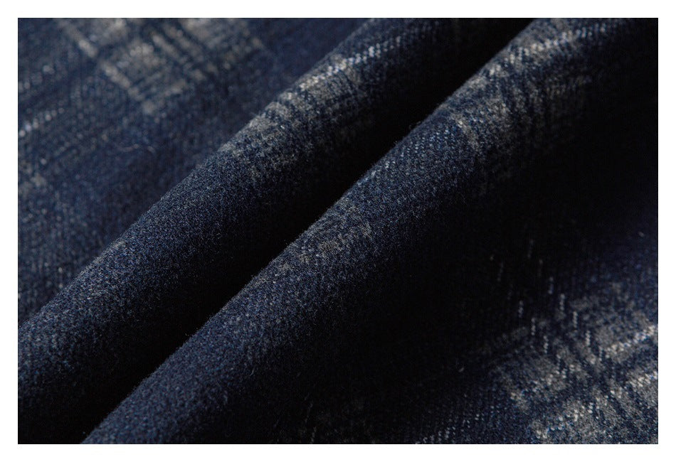 Close-up of folded dark navy plaid fabric showing its textured surface.