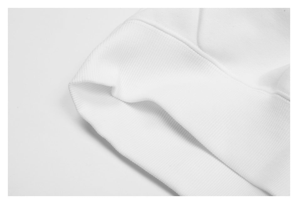 Close-up of a white garment's ribbed edge and stitched seam.