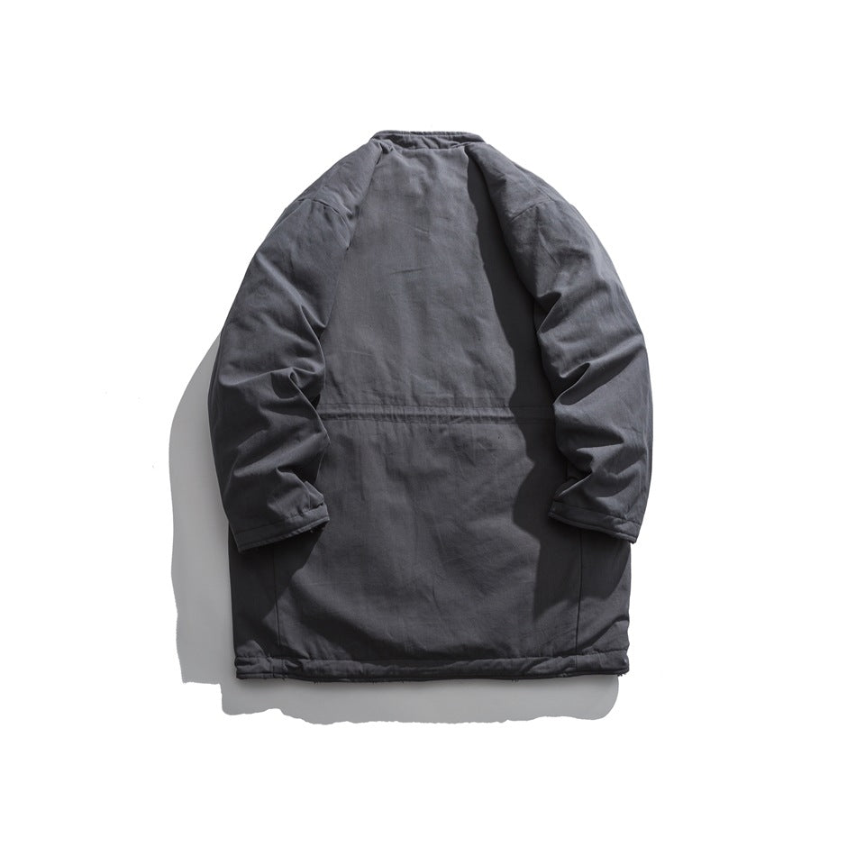 Back view of a dark gray long coat with a smooth exterior, long sleeves and a horizontal seam across the back.