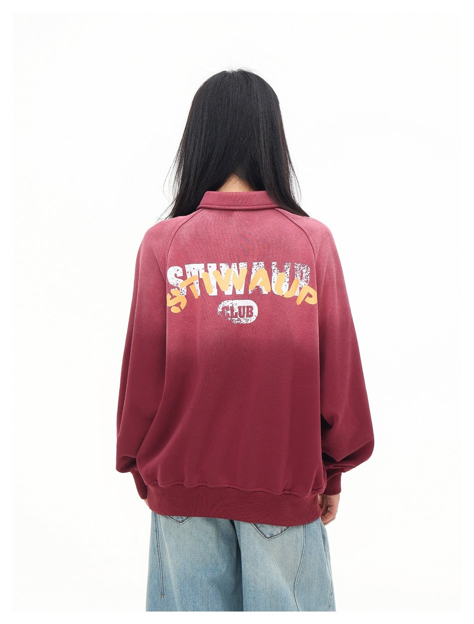 Rear view of a model wearing a burgundy pullover with large white and yellow back lettering.