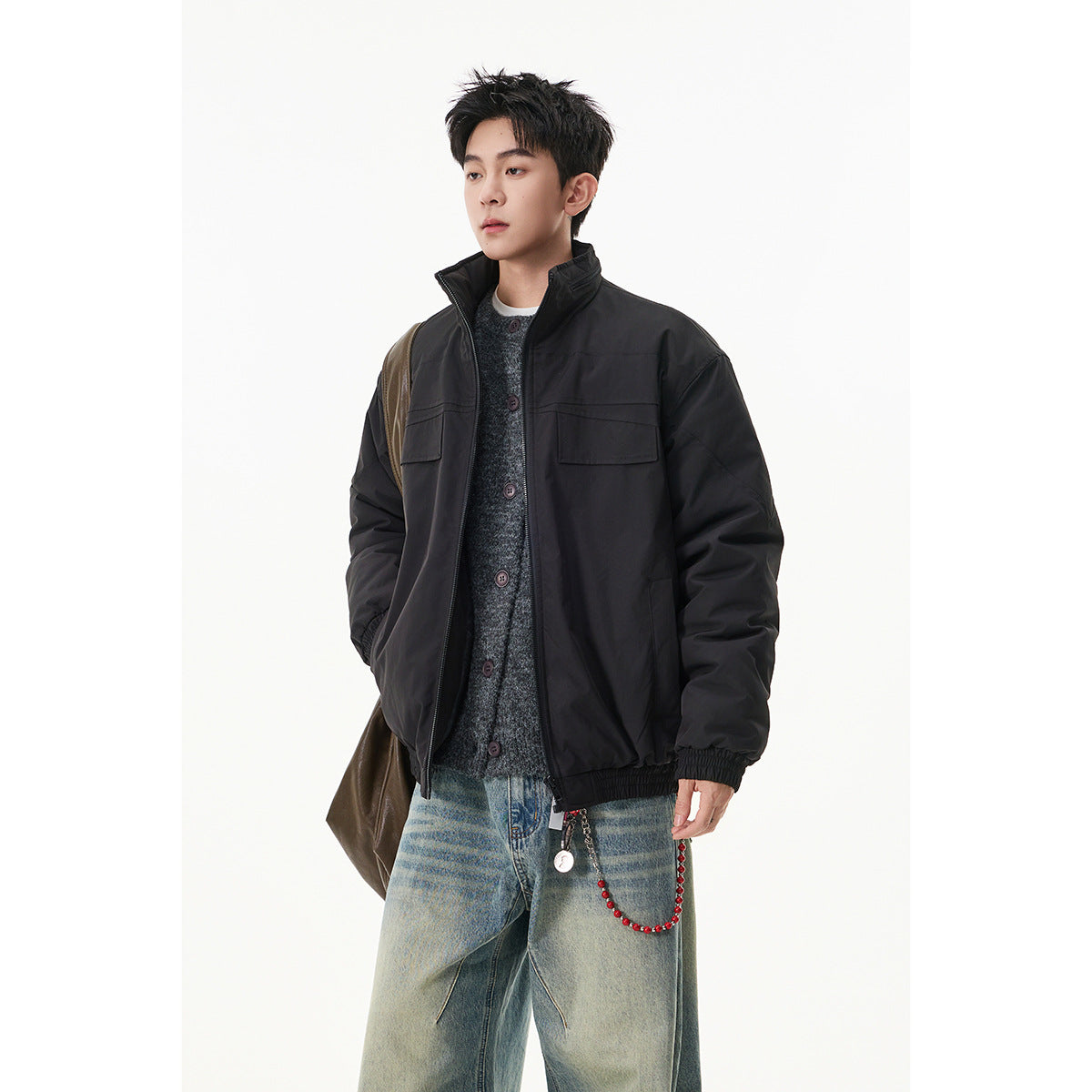 Model wearing a black zip jacket with a stand collar and two flap chest pockets.