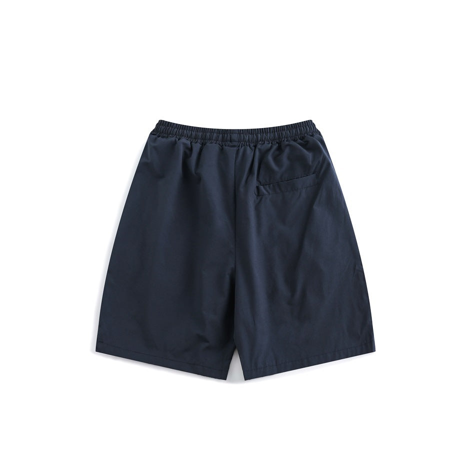 Navy shorts shown from the back, with an elastic waistband and a small rear pocket.
