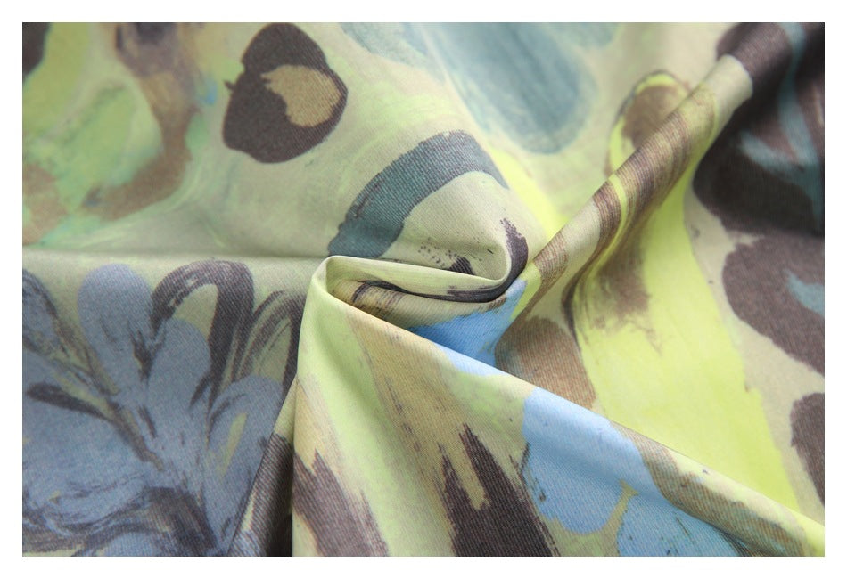 Close-up of draped fabric showing a blue, green, yellow, and brown abstract print.