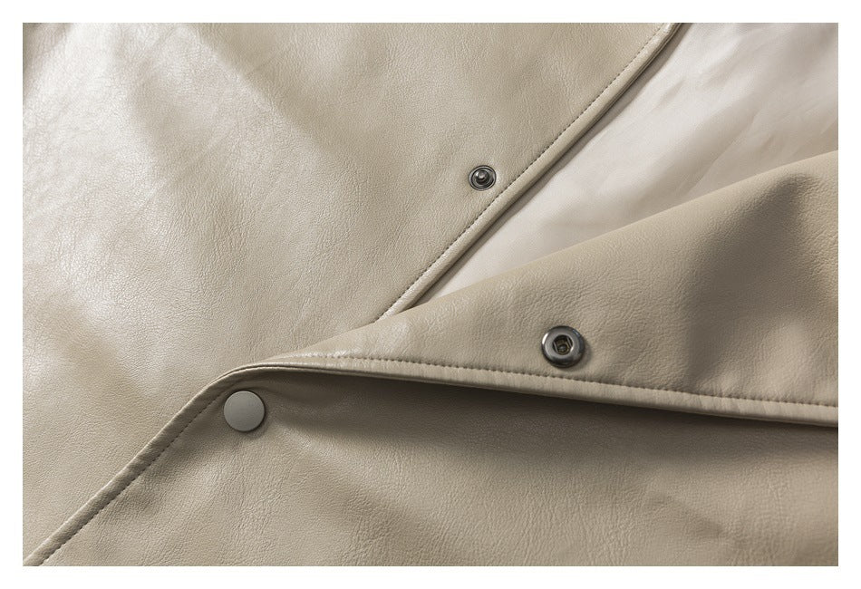 Close-up of beige jacket fabric, lining, and metal snap fasteners.