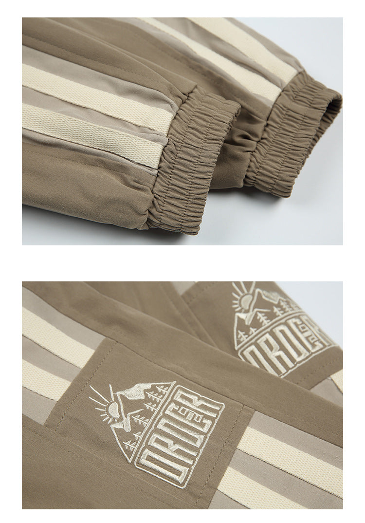 Close-ups of a taupe jacket’s gathered cuffs, cream sleeve stripes, and white embroidered graphic.