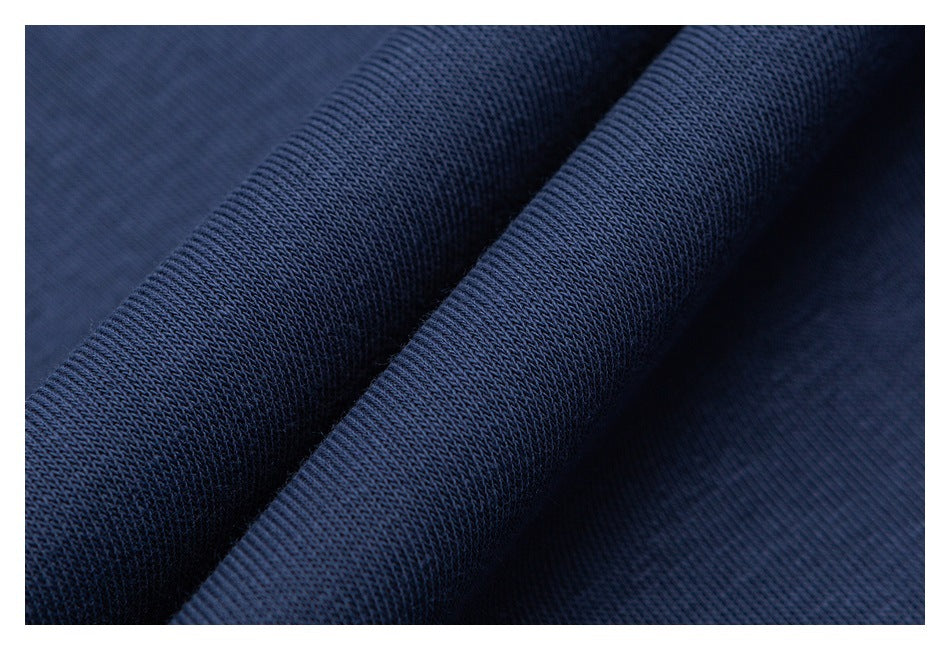 Macro view of dark blue sweatshirt fabric, showing its textured knit surface.