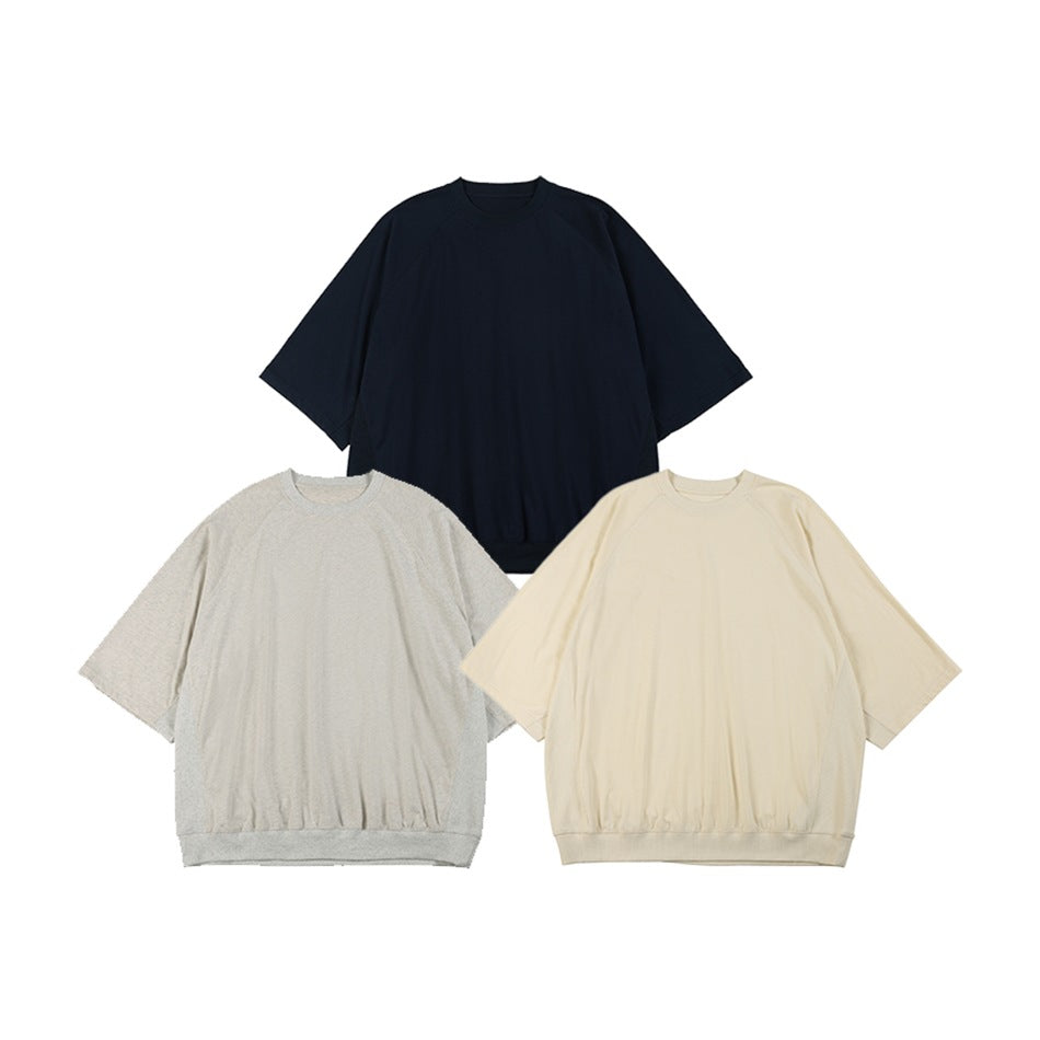 Three short-sleeve sweatshirts shown flat in navy, light gray, and ivory.