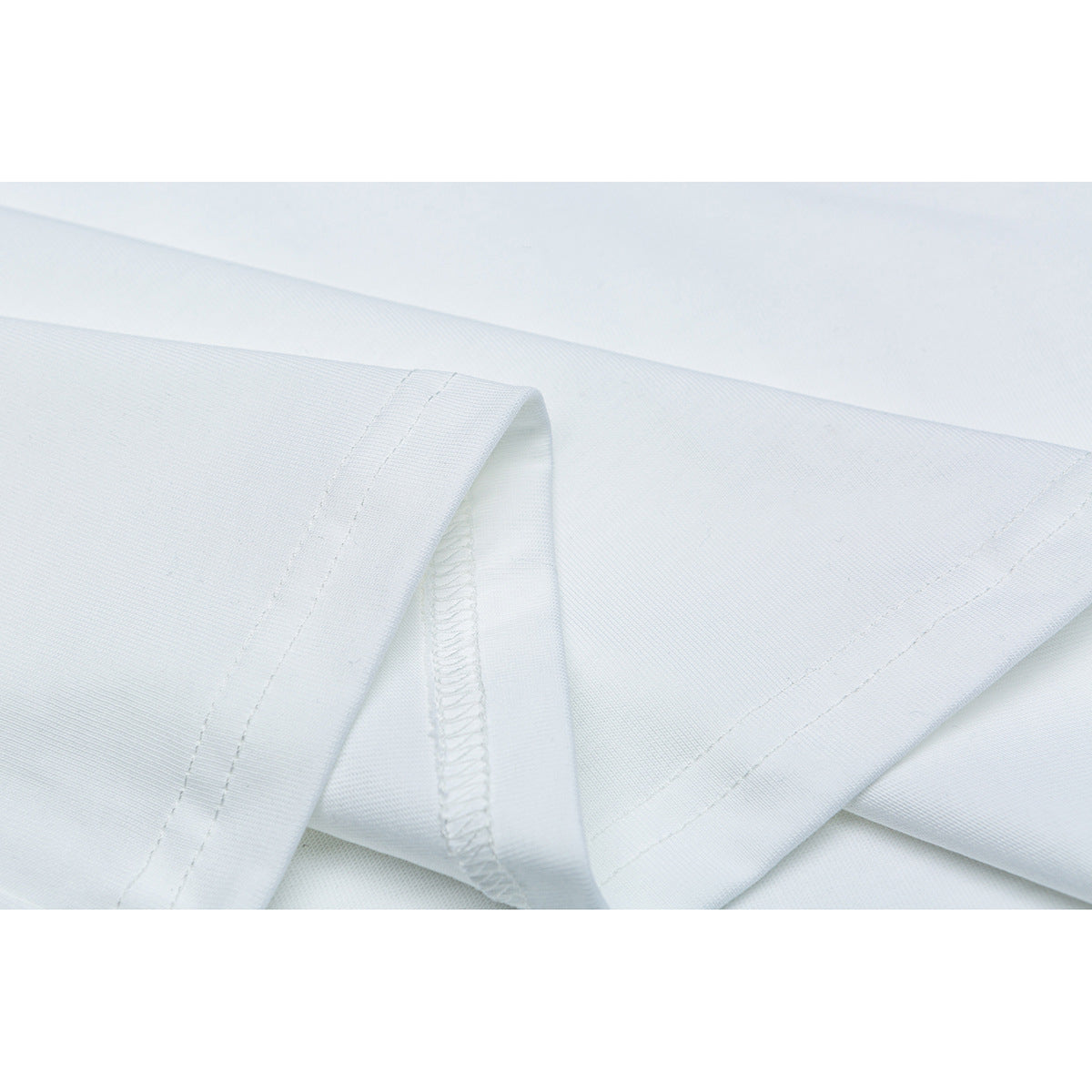 Close-up of a white T-shirt sleeve hem showing the stitching and inside seam.
