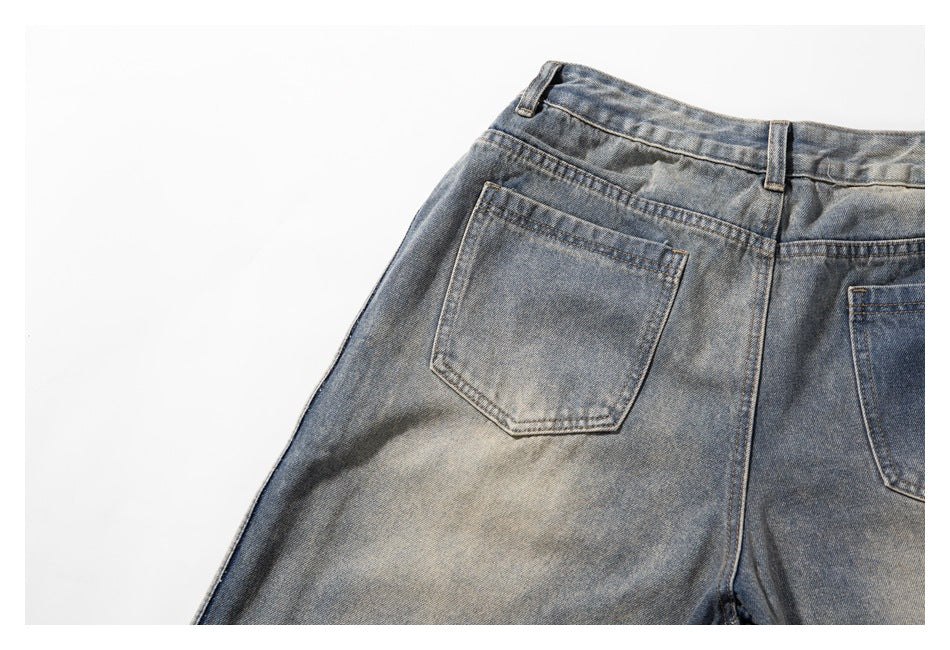 Close view of the faded blue-gray jeans' back waistband and pockets, with one pocket mostly visible.