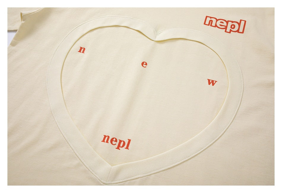 Cropped flat-lay view of a cream T-shirt with a large heart-shaped neckline detail and red lettering.
