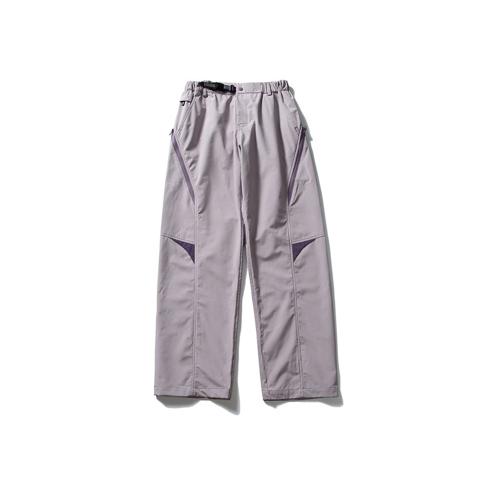 Light mauve wide-leg pants with purple zipper and knee panel accents, belt buckle and elastic waist, laid flat