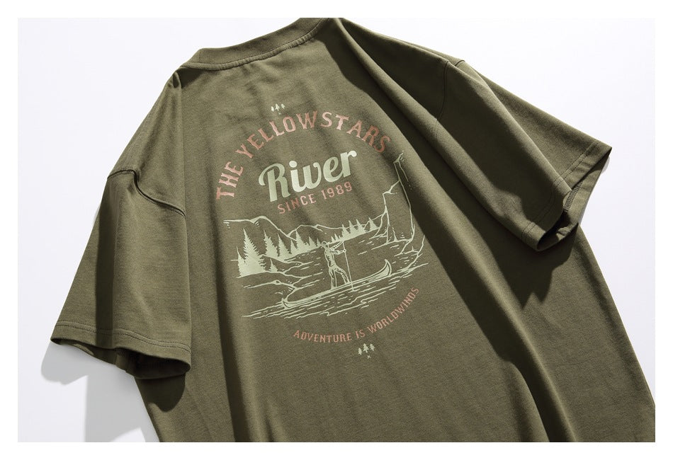 Olive green short-sleeve T-shirt laid flat, showing a large vintage-style outdoor graphic on the back.