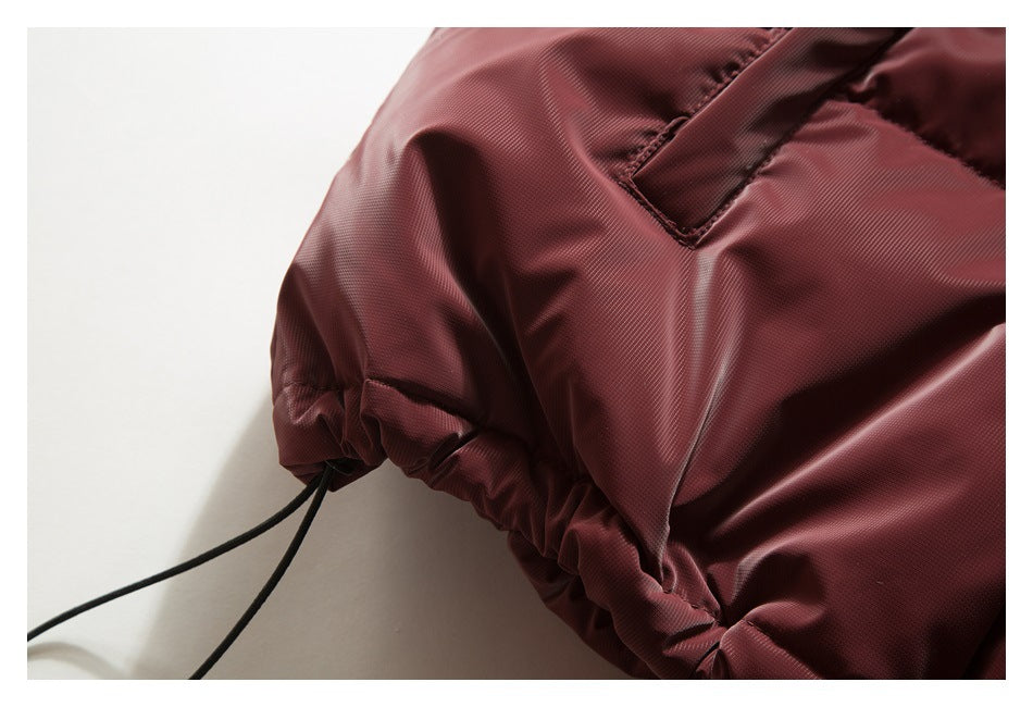 Close-up of a burgundy jacket sleeve, pocket opening and adjustable drawcord at the cuff or hem.