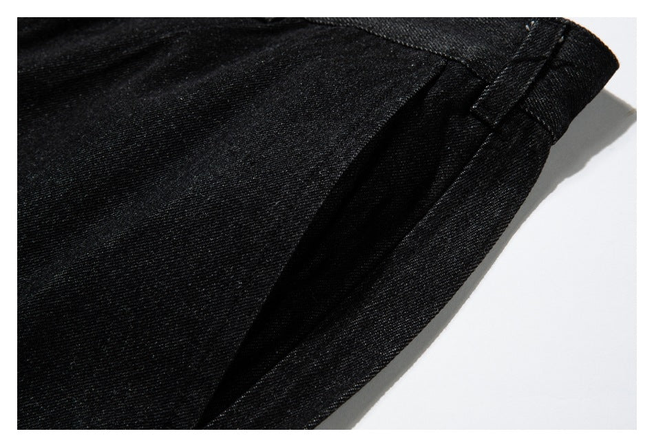 Close-up of a seam and folded edge on black denim.