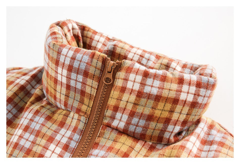 Close-up of the jacket's high plaid collar and brown front zipper.