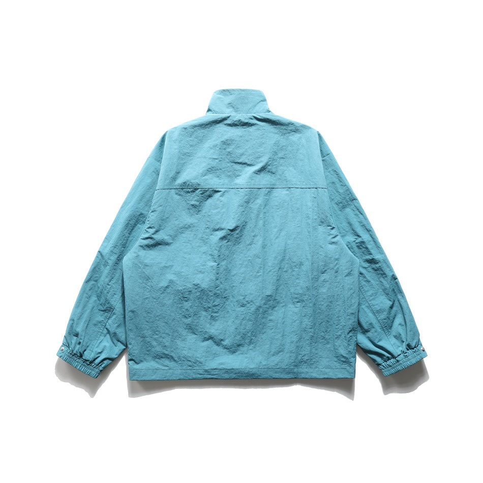 Lake blue jacket back view showing yoke seam, stand collar and elasticated cuffs with snaps