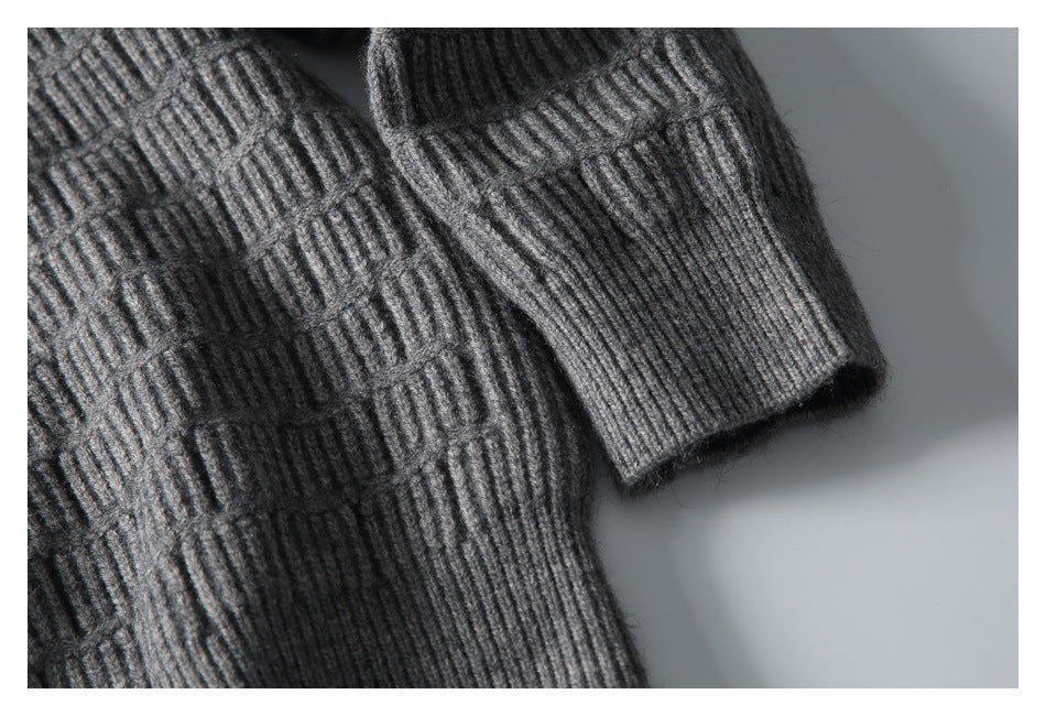 Close-up of the sweater’s textured knit sleeve and ribbed cuff.