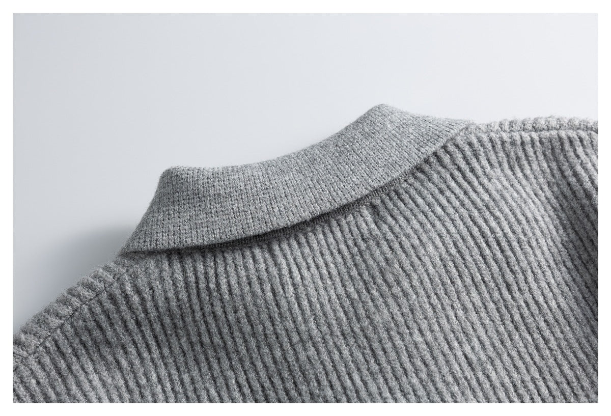 Close-up of the back collar and shoulder of a gray ribbed knit cardigan.