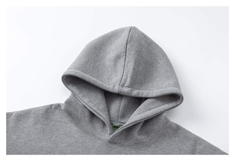 Close-up of the gray hoodie’s hood and neckline, showing the hood seams and bound opening.