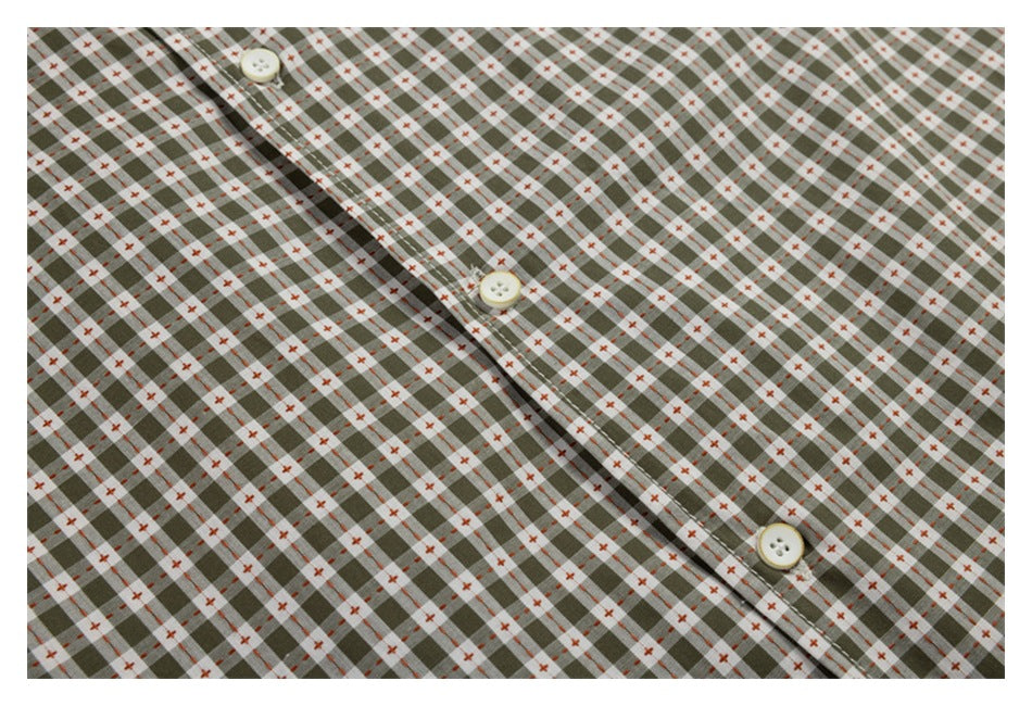 Close-up of the gray-green check shirt's front placket with three cream buttons.