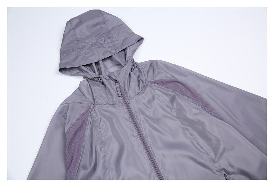 Angled close-up of a lavender-gray hooded jacket showing the hood, front zipper and contrasting mesh panels.
