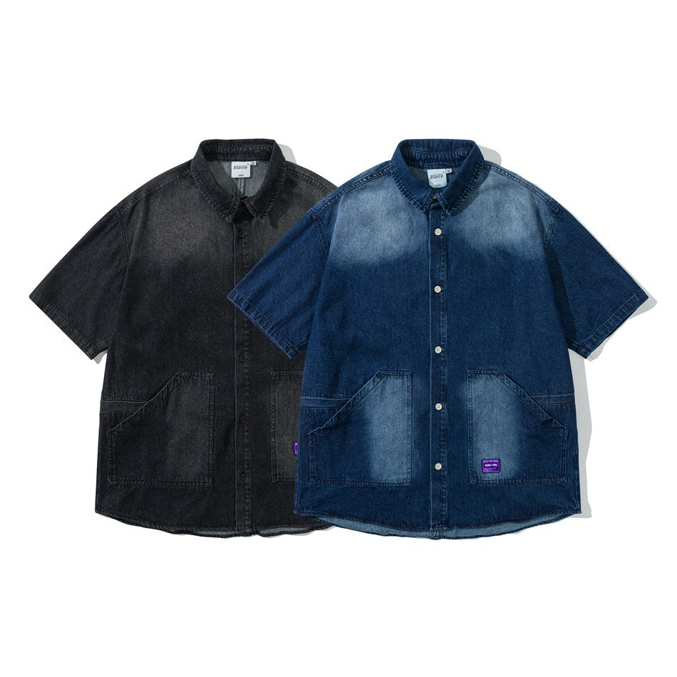 Two short-sleeve button-front denim shirts shown from the front: one black and one blue, each with two large pockets.