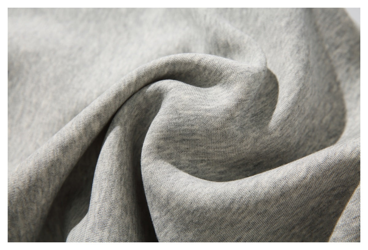 Macro view of the soft-looking gray heather fabric gathered into folds.