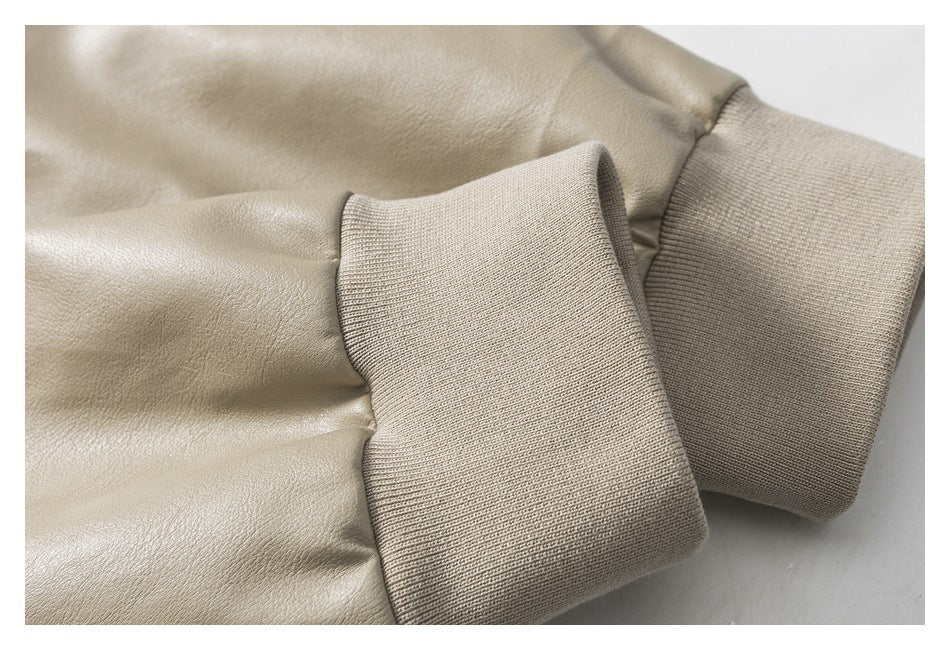 Close-up of a light taupe jacket sleeve and wide ribbed knit cuff.