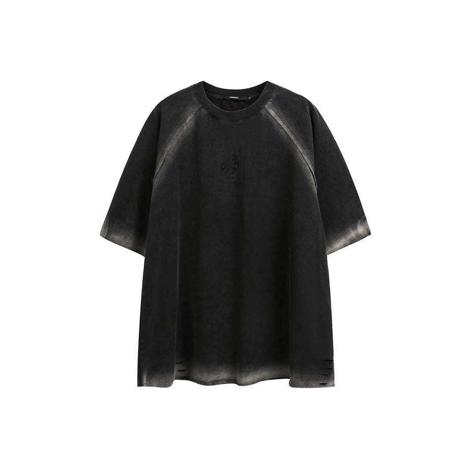 Black oversized short-sleeve raglan shirt with gray faded edges, a small raised chest emblem and distressed hem slits.