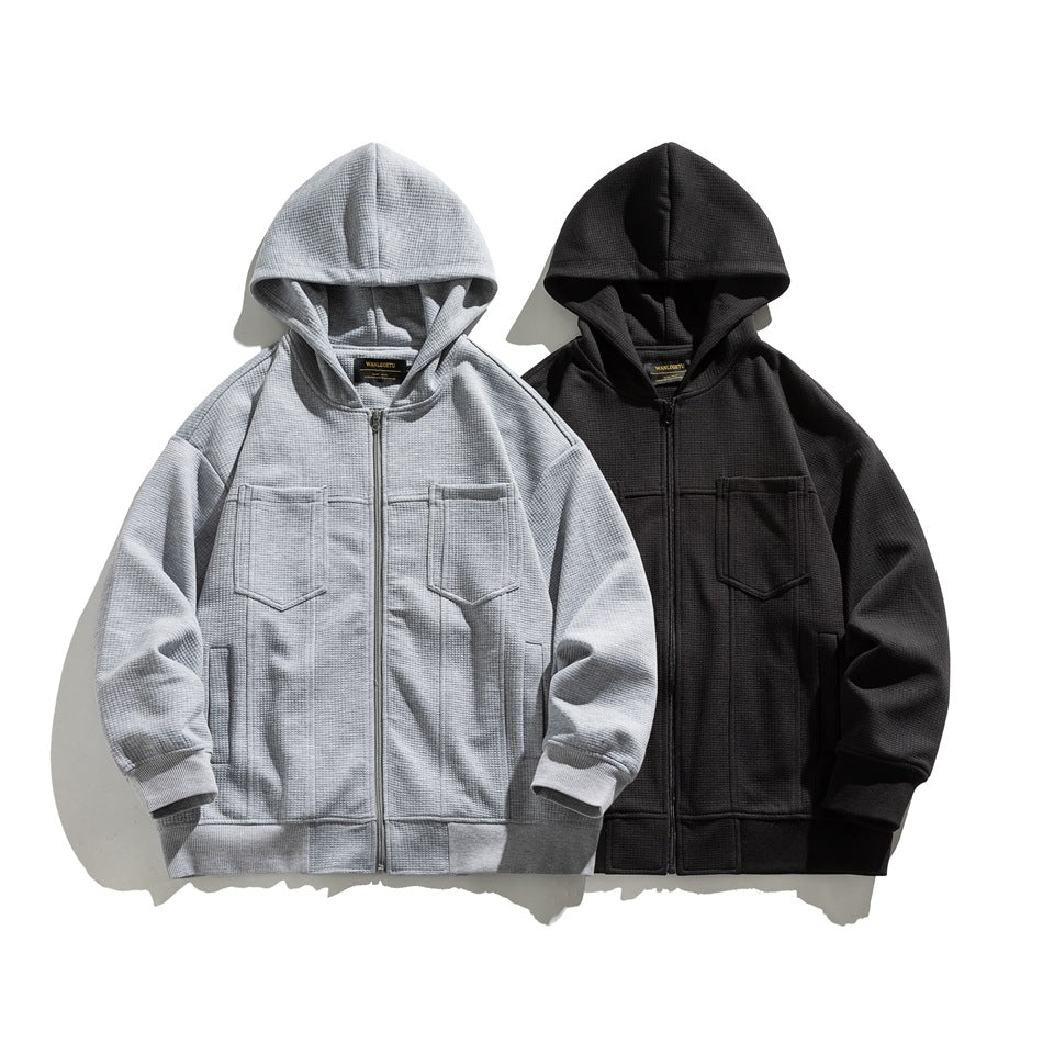 Light gray and black hooded zip jackets displayed side by side, each with chest pockets and ribbed cuffs and hems.