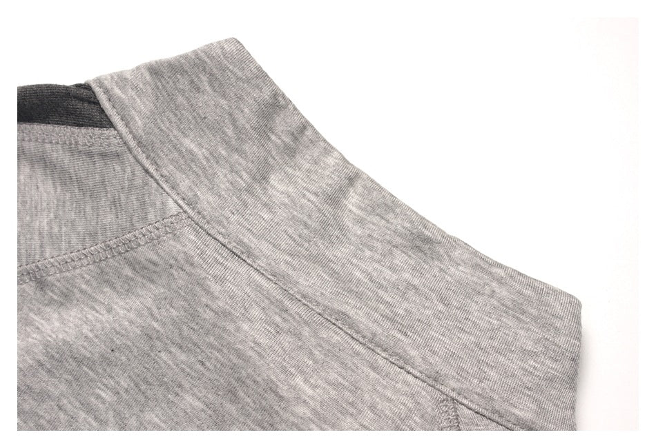 Close-up of the light gray heather collar and neckline seam with a dark inner panel.