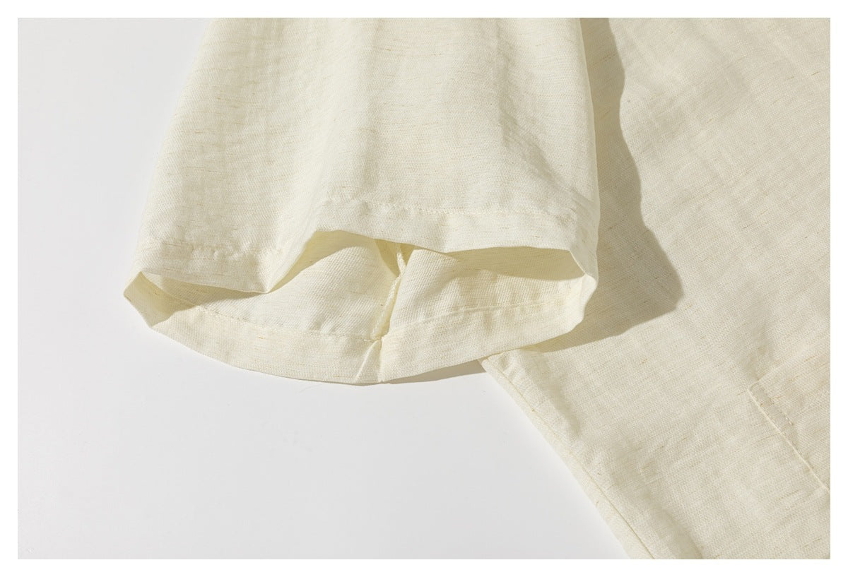 Close-up of the cream shirt's short sleeve and stitched hem.