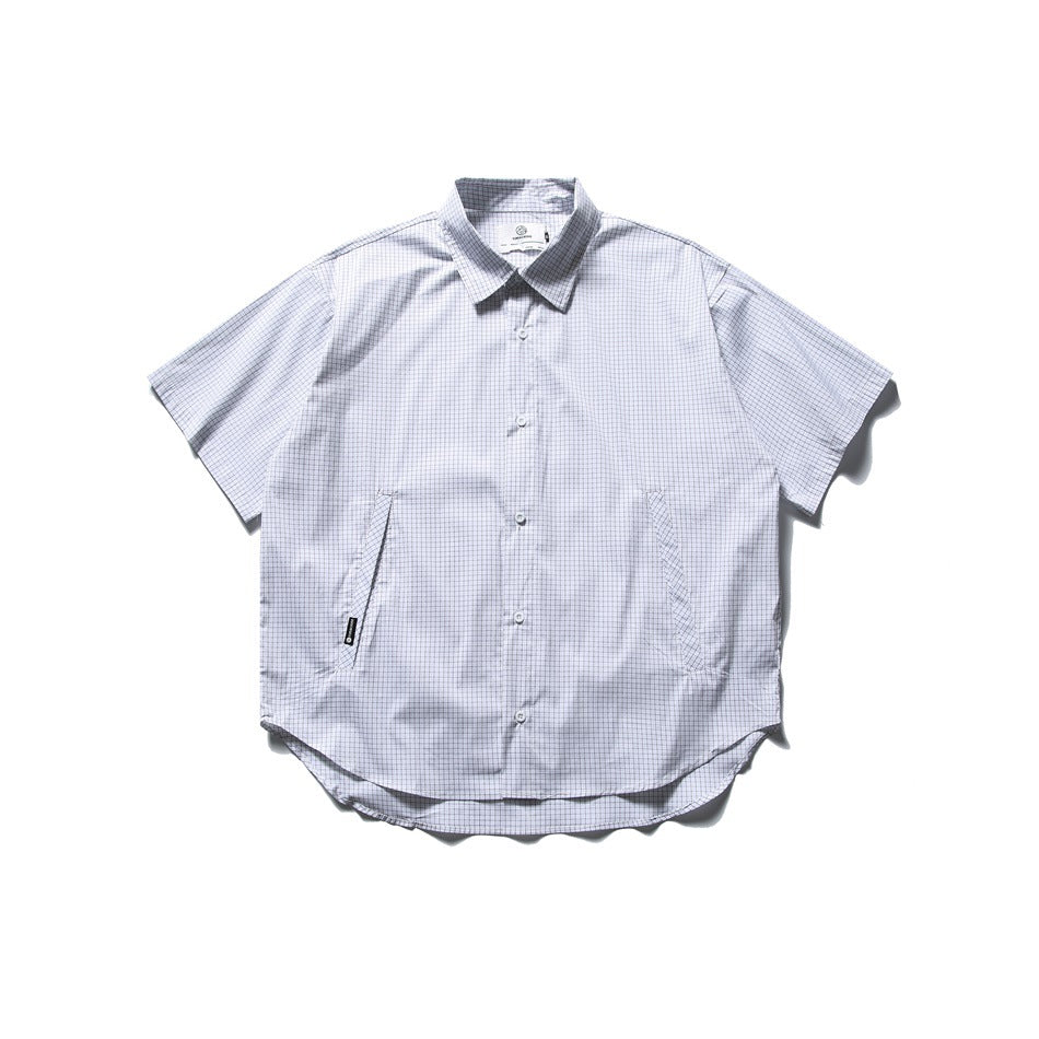 White short-sleeve button-up shirt with fine dark grid check, slanted side pockets and curved hem, flat lay