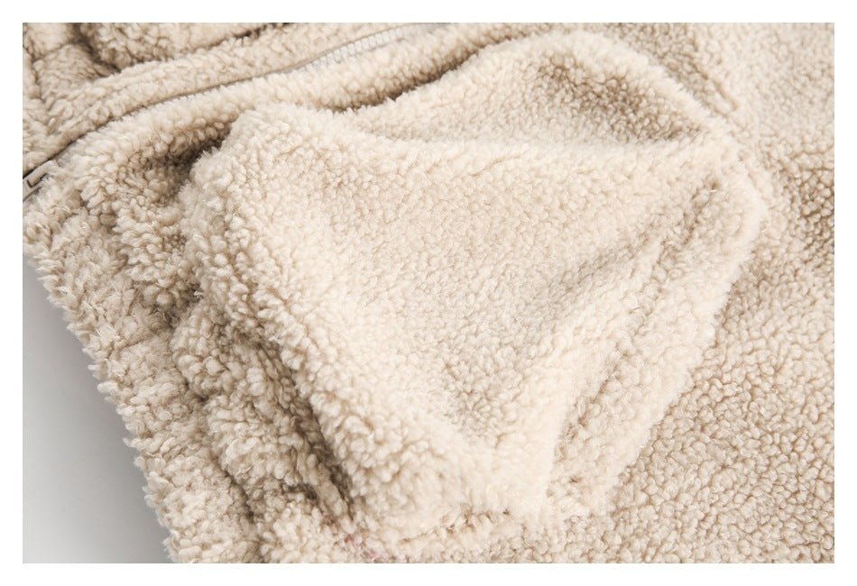 Close-up of a large pocket on a cream fuzzy jacket.