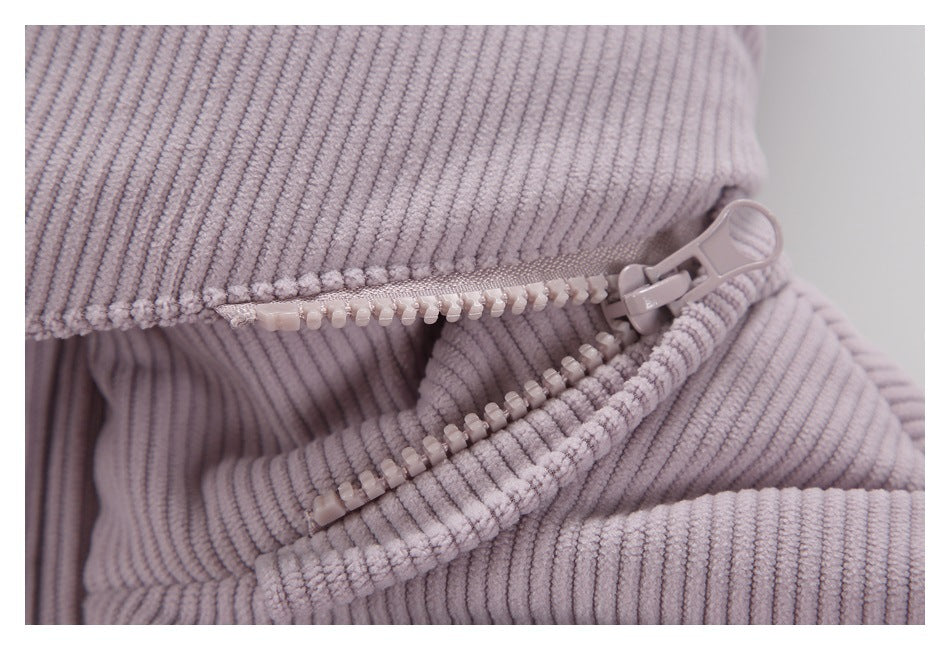 Close-up of the lilac jacket's chunky zipper and ribbed fabric.