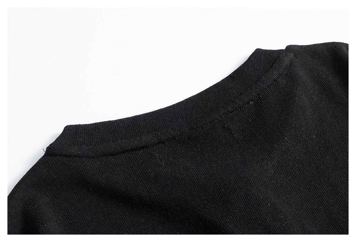 Close-up of the black garment's back neckline and shoulder seam.