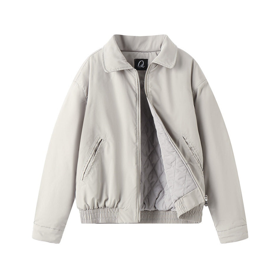 Light gray bomber jacket partly unzipped, showing the diamond-quilted gray lining and elastic hem