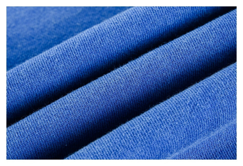 Macro view of the blue garment's knit surface, shown in soft folds.