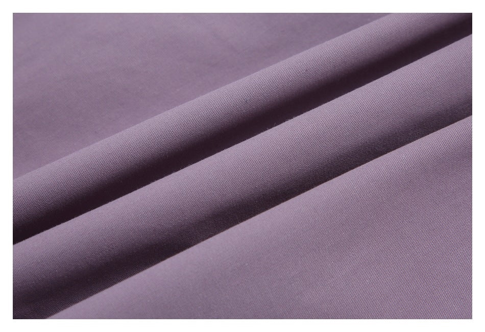 Close-up of muted lavender fabric arranged in soft folds.