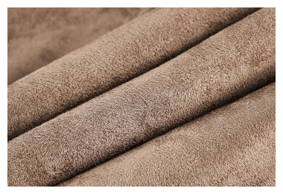 Macro view of the brown jacket's textured surface and folded fabric.